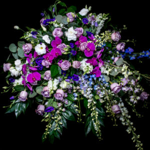 casket spray in purple, blue and white