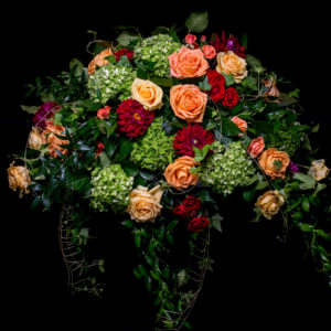 Casket spray green hydrangea yellow and orange roses